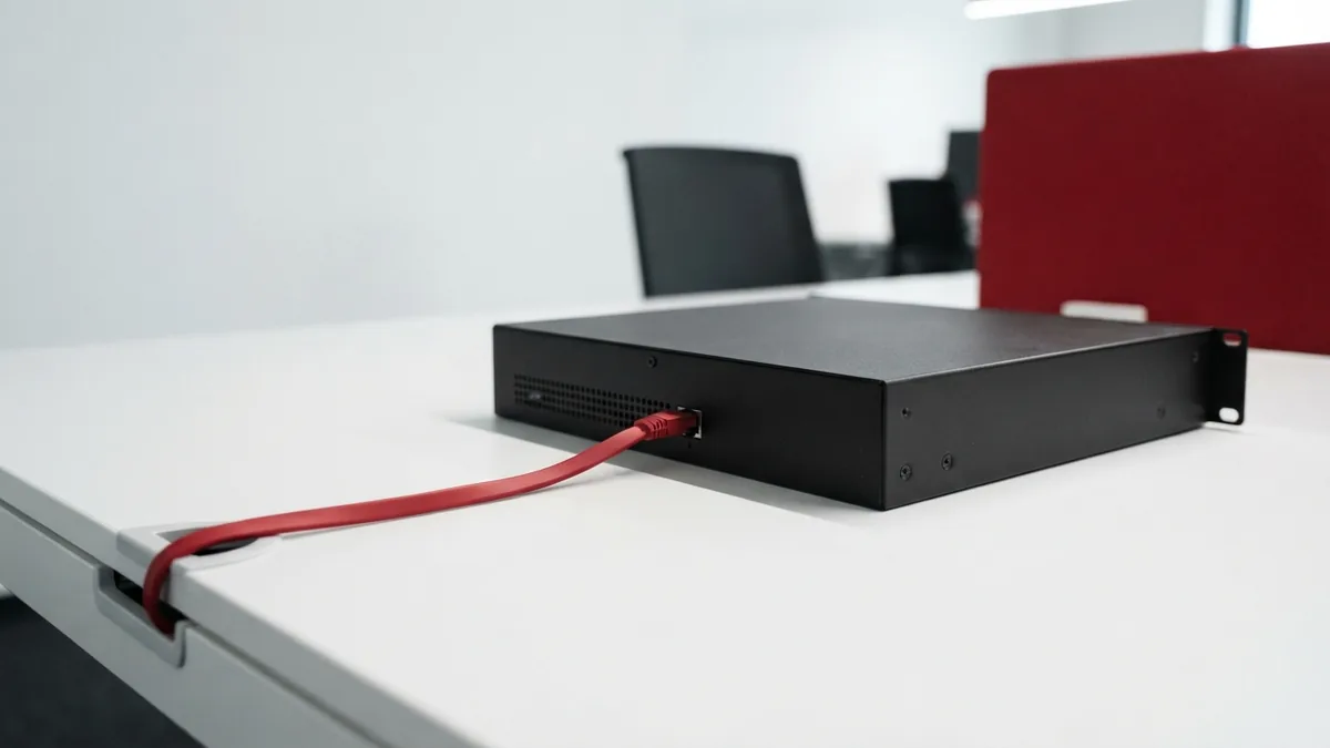 How PHP runs on a server Graphite server box with a crimson cable on a white desk for PHP processing